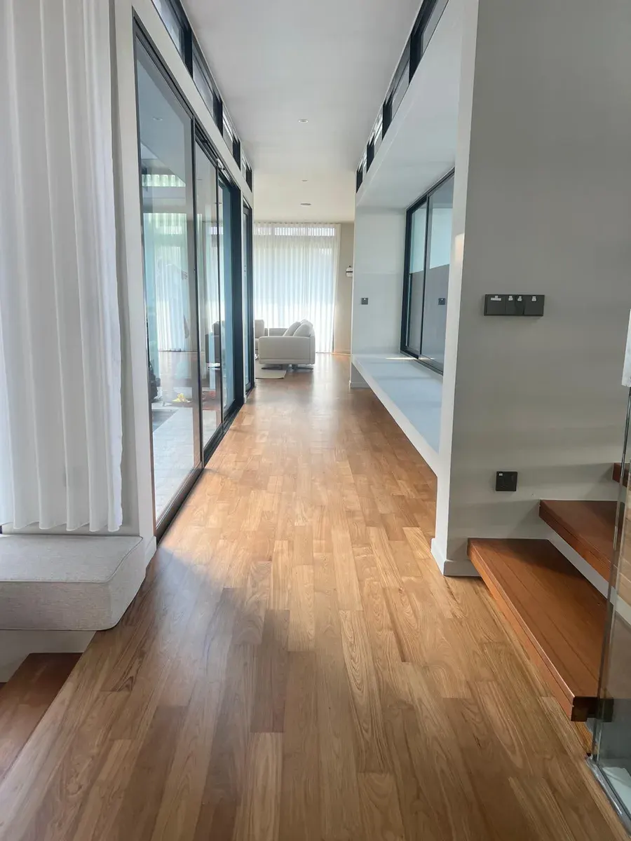 Oak wooden flooring in a bright residential hallway
